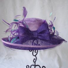Purple hues with bow and feather trim